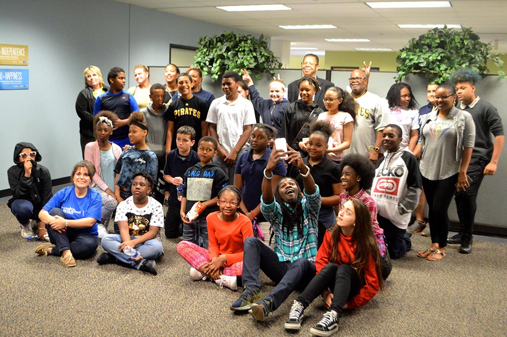 Group of students, teachers, and office people gather for a group photo