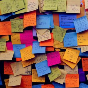 Multi-colored Post-It Notes with ideas on a wall